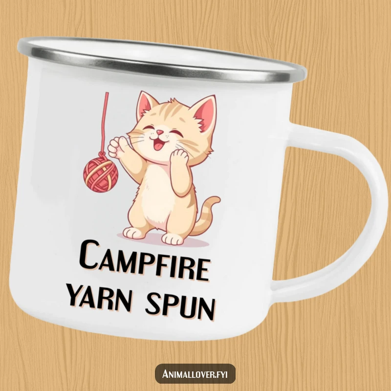 Funny camping mug with a kitten playfully batting yarn, perfect for outdoor enthusiasts. A humorous and durable mug.