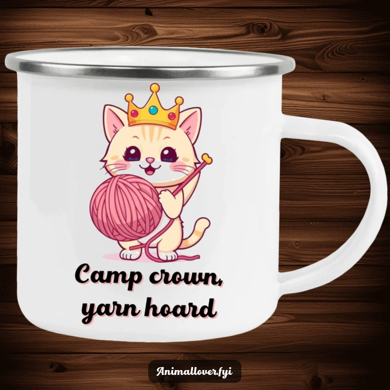 Funny camping mug featuring a crowned cat triumphantly holding a giant ball of yarn during an outdoor escapade.