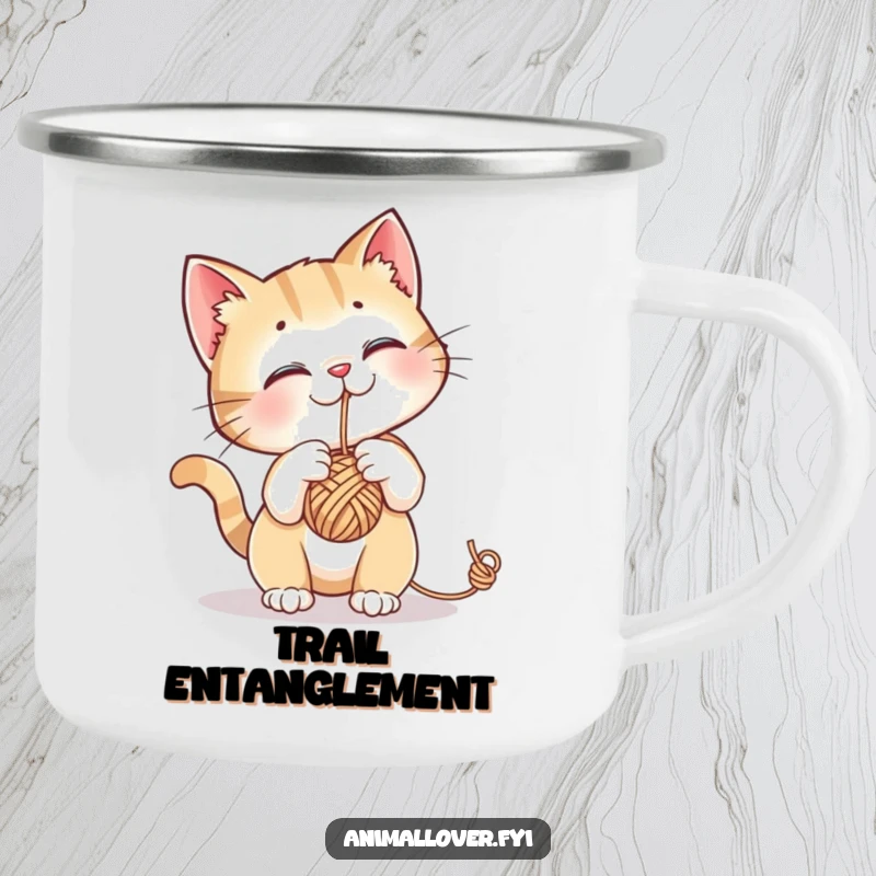 Funny camping mug with a curious cat batting at a dangling ball of yarn, perfect for outdoor cat lovers.