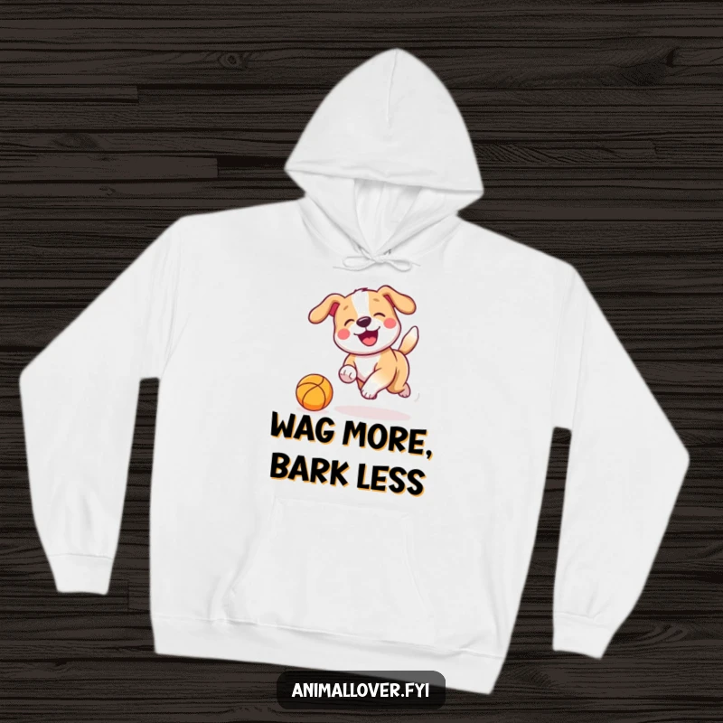 Funny Hoodie graphic of a playful dog with a rapidly wagging tail joyfully chasing a bouncing ball, full of energy.