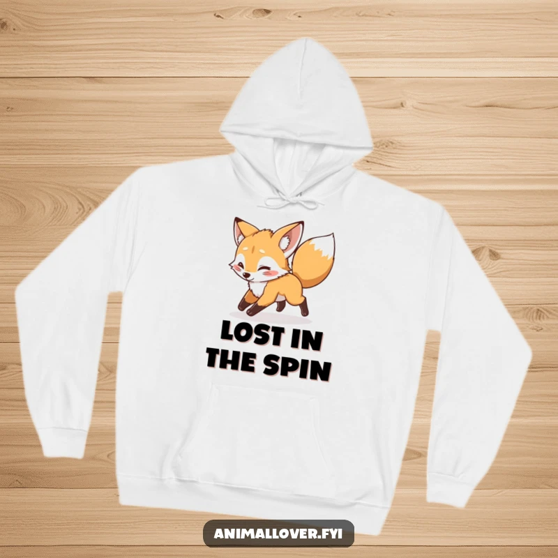 Funny mischievous fox cub chasing its tail on a hoodie, providing warmth and a playful, humorous vibe.