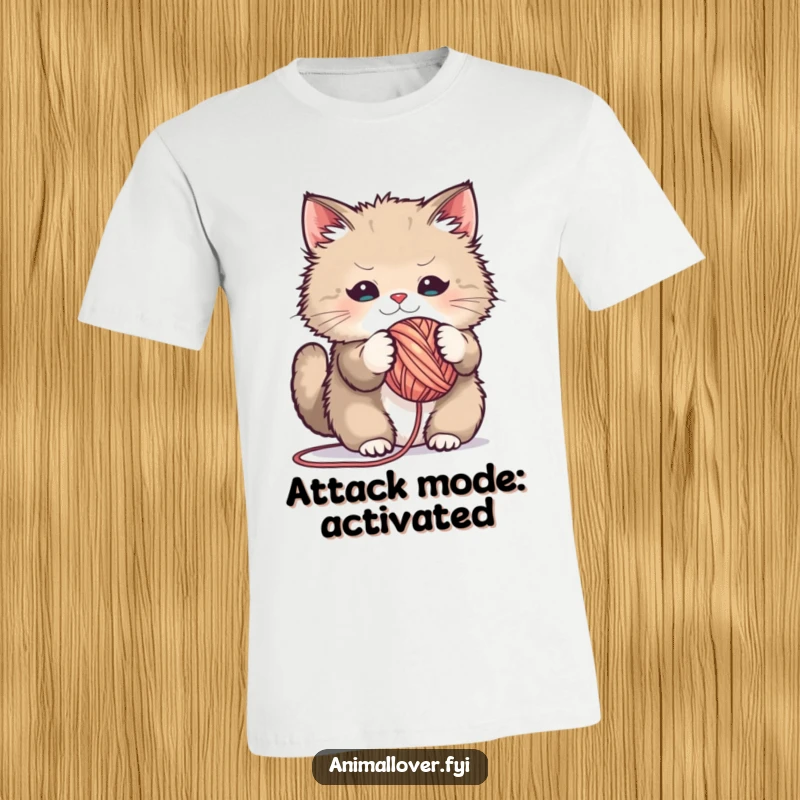 Funny t-shirt featuring a fluffy cat gleefully playing with a large ball of yarn, a humorous design for cat lovers.