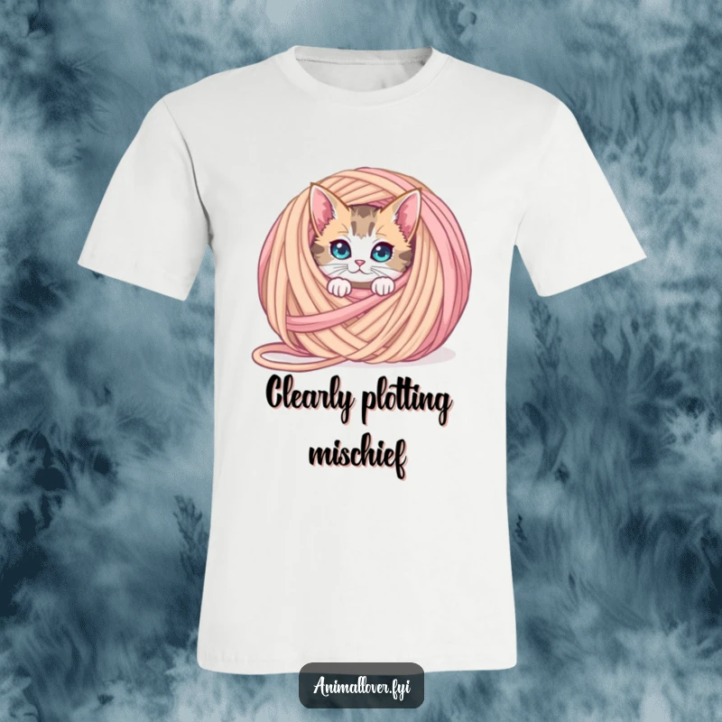 Funny curious cat t-shirt peeking from behind an oversized ball of yarn, highlighting playful mischief and feline inquisitiveness.